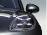 Detalle del faro delantero de un vehículo premium negro para retoque profesional de coche.